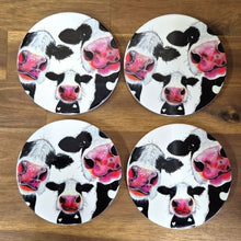 Load image into Gallery viewer, Protect your tabletops with our high-quality ceramic Cow Table Bar Coasters. This set of 4 boxed round coasters features a cute three cow cartoon image, adding a touch of charm to your home decor. Enjoy functional and stylish coasters that are perfect for any tabletop or bar setting.  Set of 4 coasters - same image | Round 10 cm diameter | Gloss protective front | Cork non slip backing | Boxed in our white coaster box with lid.