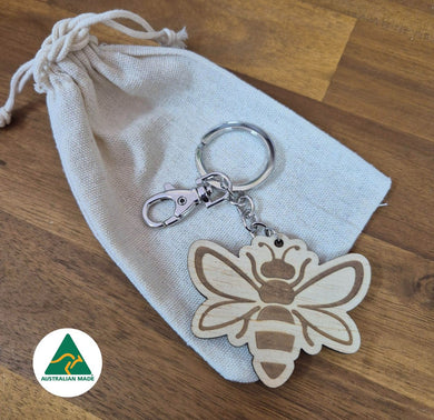 Wooden bee keychain on a white drawstring bag with an Australian Made logo.