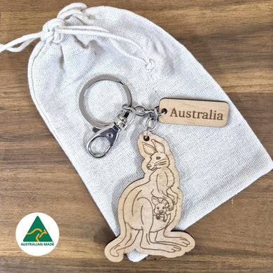 Wooden kangaroo keychain with 'Australia' tag on a white drawstring bag, Australian Made logo visible.