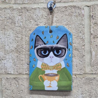 This ceramic hanging sign features a cute coffee-loving cat, making it the perfect gift for any cat lover. The small size is perfect for easy display and adds a touch of whimsy to any room. A must-have for any cat enthusiast.