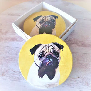 Protect your furniture in style with these adorable Dog Coasters. Featuring a cute pug design, these coasters are the perfect gift for any dog lover. Made with high-quality materials, these coasters are durable and will keep your table and bar surfaces free from spills and stains.&nbsp;  Round | Gloss finish | Cork non slip backing | White gift box with lid | Diameter 10 cm | Set of 4 - same design.