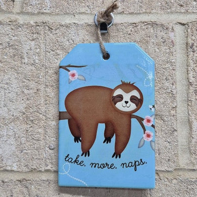 Increase your relaxation with our Sloth Hanging Sign! Made of durable ceramic, this adorable plaque reminds you to take more naps. Perfect for a baby's room, it's the ideal gift for the sloth-lover in your life.