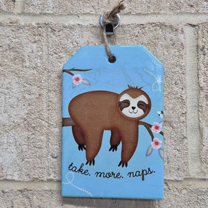 Increase your relaxation with our Sloth Hanging Sign! Made of durable ceramic, this adorable plaque reminds you to take more naps. Perfect for a baby's room, it's the ideal gift for the sloth-lover in your life.