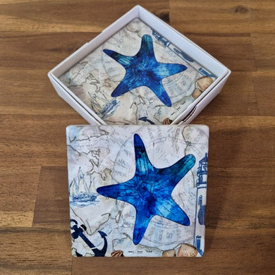 Safeguard your surfaces in style with our Starfish Coasters. Featuring a set of four coasters adorned with beautiful blue starfish, these ocean-inspired coasters are the perfect addition to any seaside themed home. Protect your furniture while adding a touch of elegance to your living space.