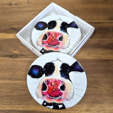 Load image into Gallery viewer, Enhance your bar / table experience with these high-quality Cow Table Bar Coasters. This boxed set of 4 ceramic coasters features a cute and playful cow cartoon image, adding a touch of whimsy to your table. Protect your surfaces while adding a touch of personality to any gathering.  Set of 4 coasters - same image | Round 10 cm diameter | Gloss protective front | Cork non slip backing | Boxed in our white coaster box with lid.