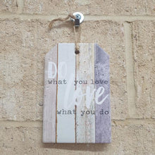 Load image into Gallery viewer, This hanging ceramic plaque sign is the perfect little gift for those looking to do what they love and love what they do. Its simple yet powerful message reminds us to pursue our passions and find joy in our work. Place it anywhere for daily inspiration.
