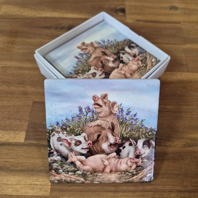 Protect your furniture with these adorable Pig Coasters. Made from high-quality ceramic, each coaster features a playful pig design, perfect for any pig lover. Comes in a set of 4 and packaged in a white box, making it the perfect gift for any occasion. Practical and charming, these coasters are a must-have for any pig lover.  Set of 4 - same design | Square | 10 x 10 cm | White box with lid | Gloss finish | Cork non slip backing.