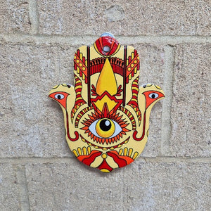 This multi-functional Hamsa Hand Of Protection serves as a trivet, plate, and hanging sign. Made from colorful ceramic, it adds a touch of charm to any kitchen or room. The Hamsa hand symbol offers protection and good luck, making it a meaningful and thoughtful gift.  In all faiths it is a protective sign. It brings it's owner happiness, luck, health, and good fortune.