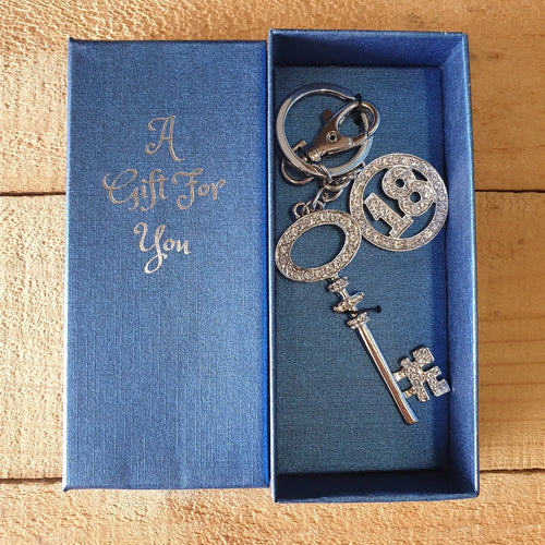18th Birthday Celebration - key / bag chain and keepsake. Large silver crystal stone key, with 18th round symbol keepsake charm.  The perfect gift for that 18th special birthday. Boxed in our beautiful blue A Gift For You giftbox.   Boxed gift 6 x 14 cm - Blue gift box - Silver Key & 18th Birthday - Silver rhinestones.  Keychains & Gifts Australia - View our store for more beautiful gifts.