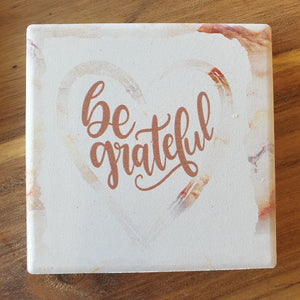 Our beautiful Be Grateful gift set - hanging ceramic plaque & boxed 4 set of coasters.  Coasters diameter - 10cm - Ceramic - Cork backing - Set of 4 - White gift box with lid.  Hanging Plaque - 10 x 15 cm -  Rope hanger - Ceramic - Cork backing   A beautiful gift to give, a beautiful saying and reminder to always be grateful.