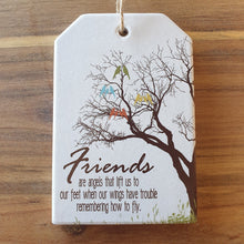 Load image into Gallery viewer, What a beautiful friendship gift - 10 x 15 cm - Ceramic - Cork backing - Rope hanger  Friends Are Angels That Lift Us To Our Feet When Our Wings Have Trouble Remembering How To Fly.  Hanging (rope) ceramic plaque sign the perfect gift for any treasured friendship.   View our full shop for more beautiful gifts - Keychains &amp; Gifts Australia.  Friendship gift - Friends - Gifts for friends - Friends are angel gifts.