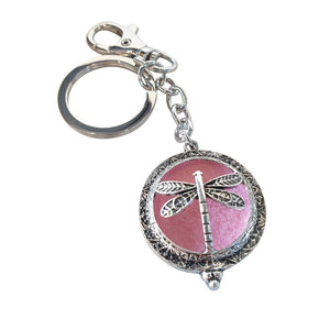Dragonfly - Dragonfly Oil Diffusor Keyring - Bag Chain - Keychain Gift.  The Dragonfly symbolizes change, transformation, adaptability and self realization.   Add a few drops of your favourite essential oils to your Dragonfly keychain pad, and hang on your keys, bag in your car or office to have benefits of your oils around you.   Silver keychain - Double mini magnet closing - Light pink oil pads x 3 - Come in  Cotton Tribal gift bag - Keychain 3.5 x 12 cm 