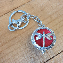Load image into Gallery viewer, Dragonfly - Dragonfly Oil Diffusor Keyring - Bag Chain - Keychain Gift.  The Dragonfly symbolizes change, transformation, adaptability and self realization.   Add a few drops of your favourite essential oils to your Dragonfly keychain pad, and hang on your keys, bag in your car or office to have benefits of your oils around you.   Silver keychain - Double mini magnet closing - Red oil pads x 3 - Come in  Cotton Tribal gift bag - Keychain 3.5 x 12 cm 