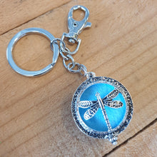 Load image into Gallery viewer, Dragonfly - Dragonfly Oil Diffusor Keyring - Bag Chain - Keychain Gift.  The Dragonfly symbolizes change, transformation, adaptability and self realization.   Add a few drops of your favourite essential oils to your Dragonfly keychain pad, and hang on your keys, bag in your car or office to have benefits of your oils around you.   Silver keychain - Double mini magnet closing - Light blue oil pads x 3 - Come in  Cotton Tribal gift bag - Keychain 3.5 x 12 cm 