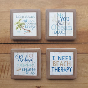 Beach Life Magnet Set - Ocean Themed Kitchen Fridge Magnets - Set Of 4. A beautiful set of 4 x ceramic beach / ocean themed magnets with sayings.  Life's at ease with an ocean breeze Me you & the ocean blue Relax - Unwind - Enjoy I need beach therapy The perfect gift for any beach house or lover of the ocean.  4 x ceramic magnets - Matt finish - Diameter 5 cm - Magnetic backing.