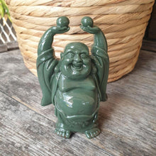 Load image into Gallery viewer, The Legend behind Laughing Buddha  According to legend Laughing Buddha is based on a Chinese monk who lived over 1000 years ago. He roamed from one village to the other, carrying a cloth sack that had sweets and toys that he distributed amongst children. His jolly smile and protruding belly also gave him the name ‘Happy Buddha’.  Laughing Buddha can be seen carrying different things. Let’s understand these symbols and their importance.