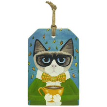 Load image into Gallery viewer, Our very popular coffee cat, now come&#39;s in a hanging ceramic plaque to finish your set of coffee cat collection.  Also available in coasters, kitchen trivet and magnets. View our full shop Keychains &amp; Gifts Australia for more Purrrfect gifts.   10 x 15 cm + Rope hanger - Ceramic - Cork backing - Gloss finish  Cat gifts - Cat gift - Hanging cat sign - Cat people gifts - Cat lover Gifts