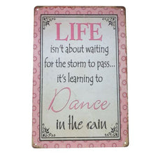Load image into Gallery viewer, Elevate your home décor with this Dance In The Rain metal sign. Its beautiful design and meaningful message serve as a reminder to always find joy in life&#39;s challenges. Give it as an uplifting gift to a loved one, or keep it for yourself to inspire positivity in your own home.  Life isn&#39;t about waiting for the storm to pass it&#39;s about learning To Dance In The Rain.
