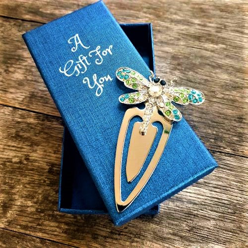 Dragonflies are truly beautiful, and dragonfly lovers will adore our dragonfly collection. Our beautiful hand made bookmarks are a truly stunning gift. Use as an everyday bookmark when ready your latest book, or bookmark your favourite recipe on your favourite book in the kitchen.  Your beautiful dragonfly will come boxed in our beautiful A Gift For You blue gift box | 6 x 14 cm | Dragonfly - Full length 9 cm | Width 6 cm | Green, silver & blue rhinestones | Silver metal.