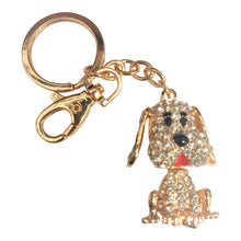 Load image into Gallery viewer, Super cute gold hand made puppy, a pawsome gift for doggy lovers.  Gold metal | Full length of keychain 11 cm | Puppy dog 3 x 5 cm | Movable floppy ears &amp; tail | Hand painted | Silver rhinestones | Comes in a beautiful cotton organza gift bag - colours will vary.   View our full range of gifts, we have something for everyone.  Keychains &amp; Gifts Australia - we wholesale Australia wide. Contact us today. 
